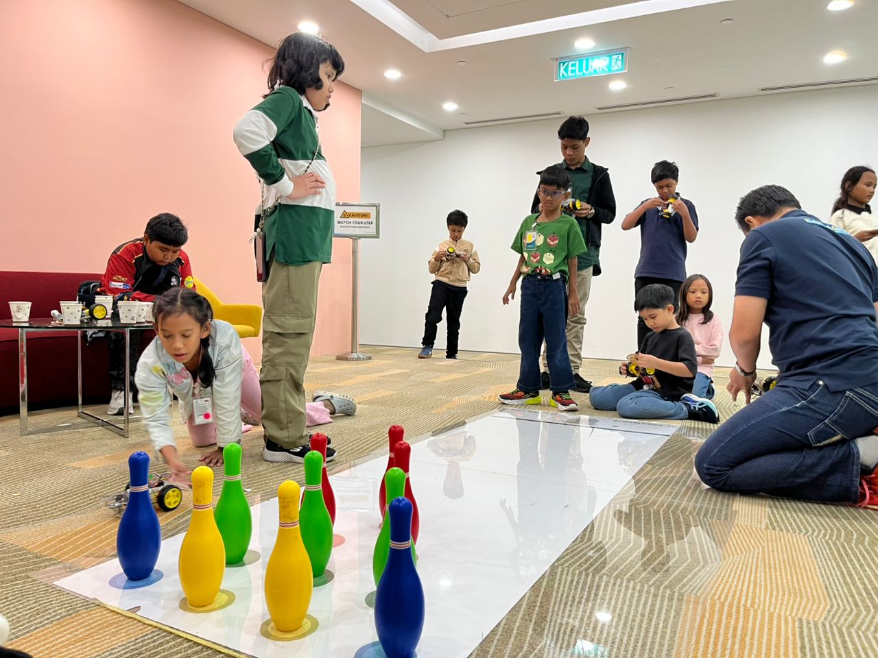 Students testing robot cars in a bowling challenge